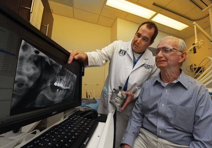 Dr. Mike Pruett meets with Hugh Morton. Photo By Phil Jones.