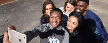 Students wear clothes with the new Augusta University brand