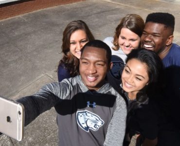 Students wear clothes with the new Augusta University brand