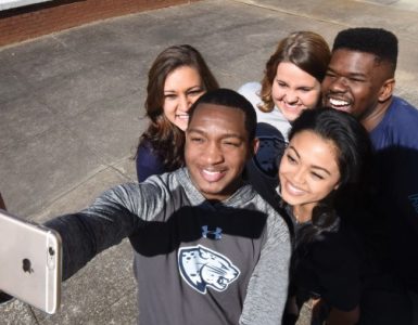 Students wear clothes with the new Augusta University brand