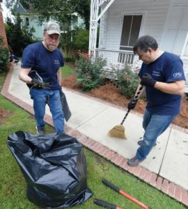 Vice Dean Kevin Frazier does yard work at the Christ Community Health Center.