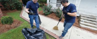 Vice Dean Kevin Frazier does yard work at the Christ Community Health Center.