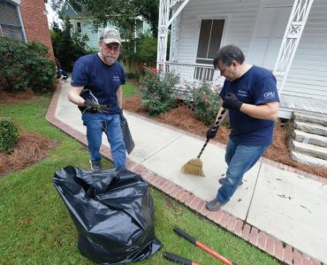 Vice Dean Kevin Frazier does yard work at the Christ Community Health Center.
