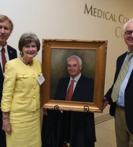 Dean David Hess, artist Sandra T. Colquitt and Dr. Peter F. Buckley, MCG’s 26th dean, unveil Buckley’s portrait at Alumni Weekend.