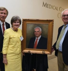 Dean David Hess, artist Sandra T. Colquitt and Dr. Peter F. Buckley, MCG’s 26th dean, unveil Buckley’s portrait at Alumni Weekend.
