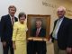 Dean David Hess, artist Sandra T. Colquitt and Dr. Peter F. Buckley, MCG’s 26th dean, unveil Buckley’s portrait at Alumni Weekend.