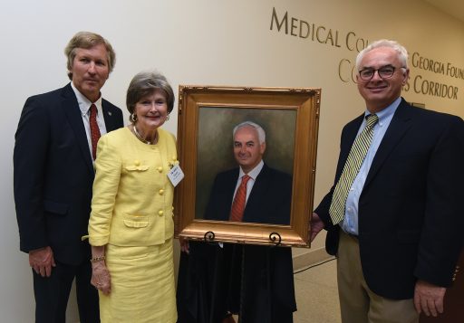 Dean David Hess, artist Sandra T. Colquitt and Dr. Peter F. Buckley, MCG’s 26th dean, unveil Buckley’s portrait at Alumni Weekend.