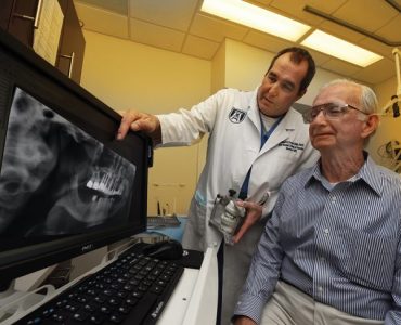 Dr. Mike Pruett meets with Hugh Morton. Photo By Phil Jones.