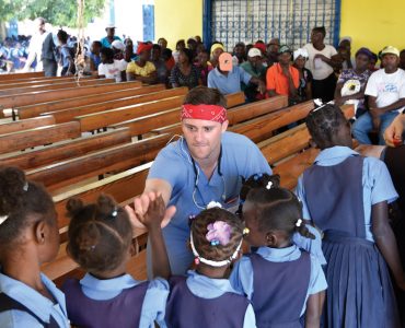 Ben Collins (Class of 2018) greets children in Haiti. Submitted photo