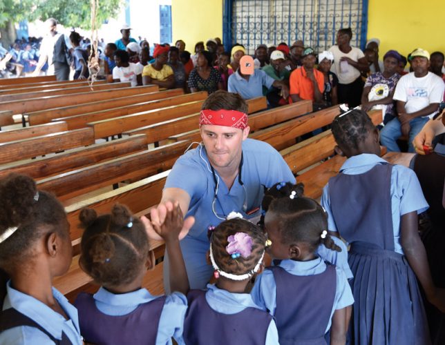 Ben Collins (Class of 2018) greets children in Haiti. Submitted photo