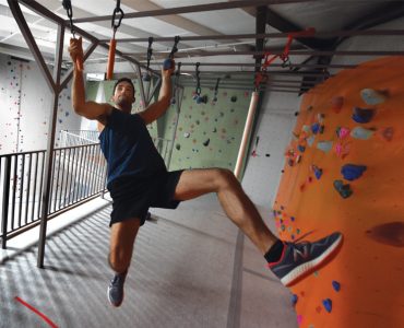 Jackson Griffeth scales ninja obstacles at Active Climbing Augusta. Photo by Phil Jones.