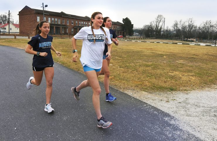 Lara Way, center, trains with teammates McKenzie Knudsen and Sinead O’Bryant.