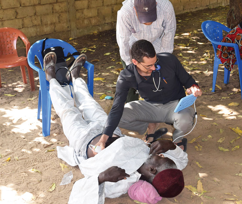 Dr. Daniel Kaminstein uses a portable ultrasound on an international mission