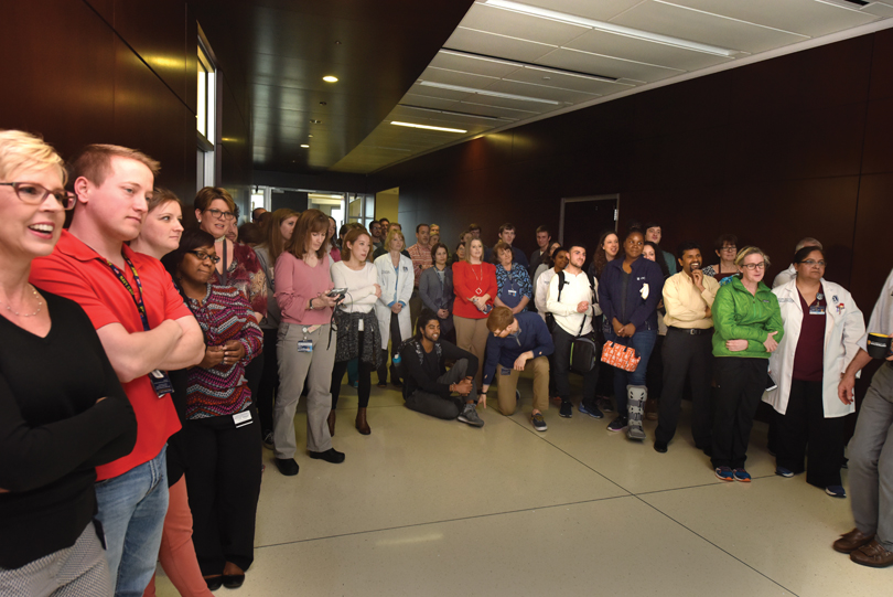 Students, faculty, and staff gather for the unveiling of the portrait.