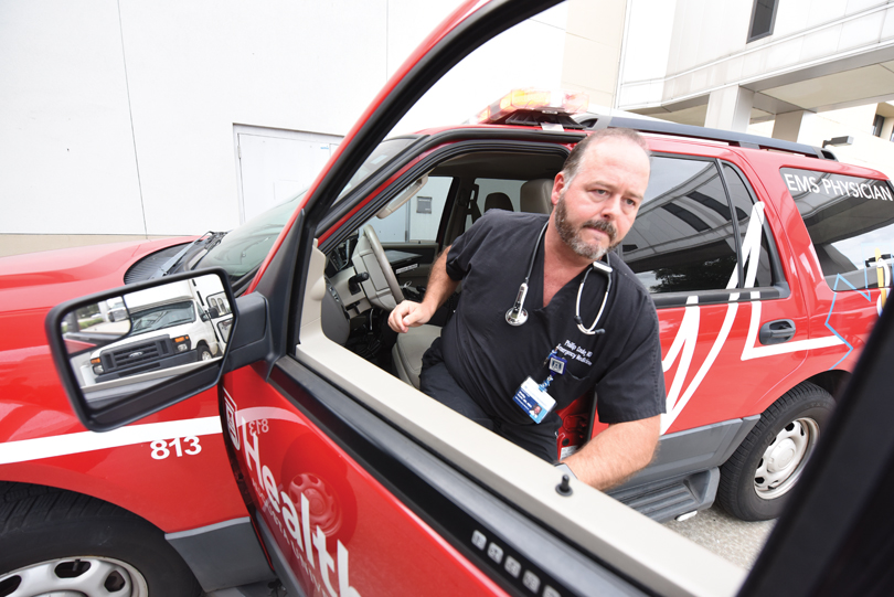 Dr. Philip Coule exits an EMS Physician vehicle.