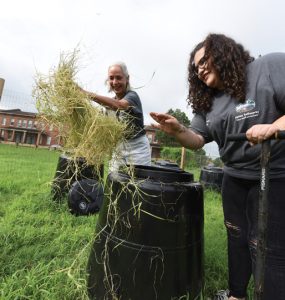 Dr. Donna Wear and Bryauna Barrera (BS '18) sort through compost barrels. Photo by Phil Jones