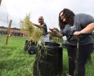 Dr. Donna Wear and Bryauna Barrera (BS '18) sort through compost barrels. Photo by Phil Jones