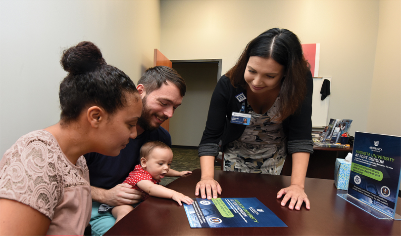 Alejandra Miles, right, meets with Stephanie Ortiz and Edward Fulk Jr. with his daughter Luna. Photo by Phil Jones.