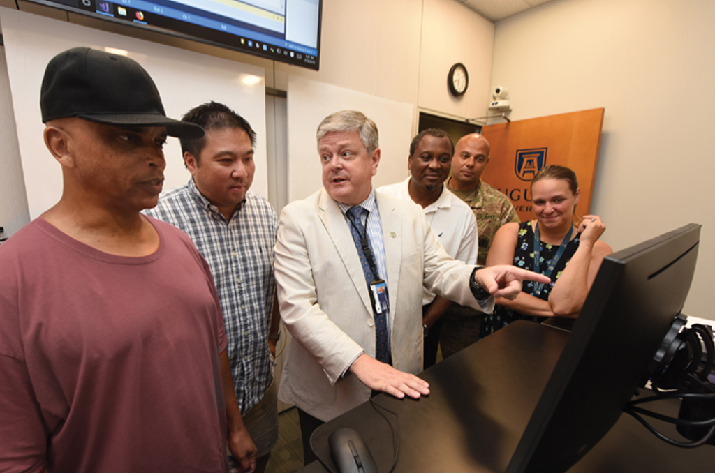 Steve Weldon, center, instructs computer science classes. Photo by Phil Jones.