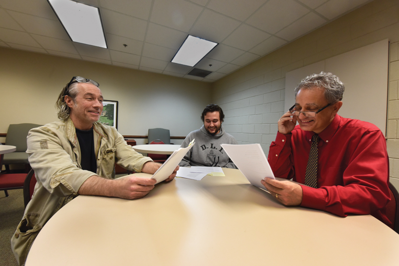 Book writer and director Doug Joiner, left, goes over the script with Mark Swanson and assistant director Benjamin Evans, center. 