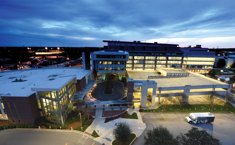 The Georgia Cancer Center at dusk, with the Ribbons of Hope sculpture hanging in the atrium (near left). Photo By Phil Jones | Nikon d810, 14.0 mm lens, 1/20 sec@f/4.5, ISO 1600