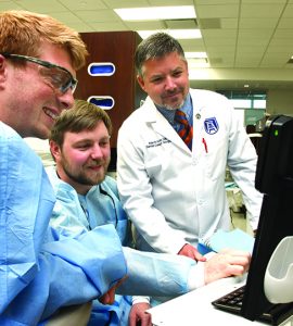 Dentist and students smiling