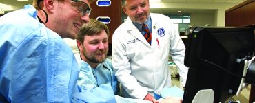 Dentist and students smiling