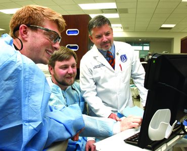 Dentist and students smiling