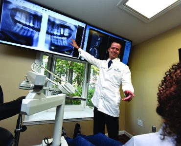 Dentist pointing at x-ray