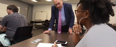 Man working with female student