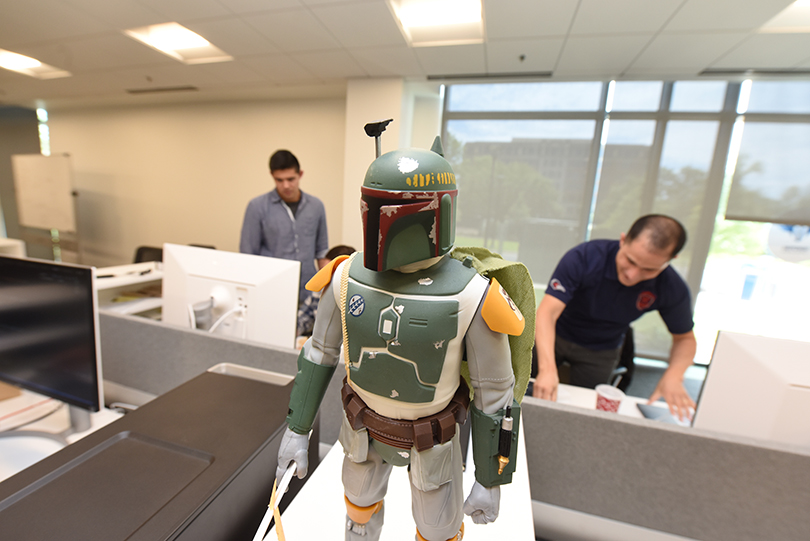 Boba Fett figure with cyber workers in background