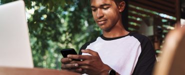 Young man looking at smartphone.