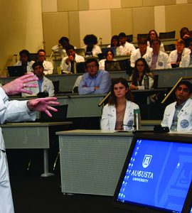 Dr. D. Douglas Miller addresses class