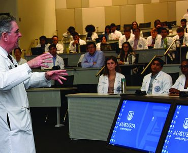 Dr. D. Douglas Miller addresses class