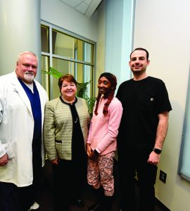 Quendella Huggin, Dean Carol Lefebvre and others smiling at camera