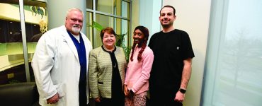 Quendella Huggin, Dean Carol Lefebvre and others smiling at camera