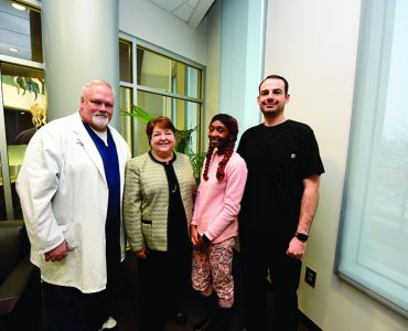 Quendella Huggin, Dean Carol Lefebvre and others smiling at camera