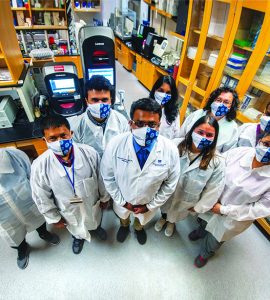 masked researchers in lab