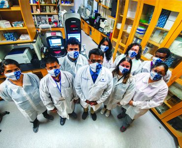 masked researchers in lab