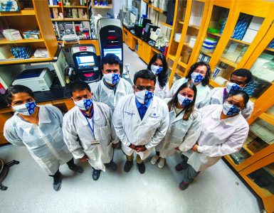 masked researchers in lab