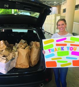 woman holding Thank You sign