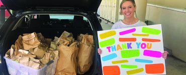 woman holding Thank You sign