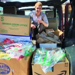 woman with boxes of donations