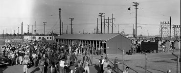 historical photo of workers leaving plant