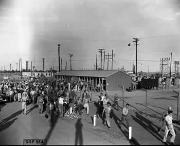historical photo of workers leaving plant