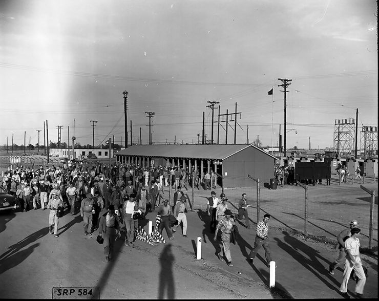 historical photo of workers leaving plant