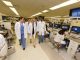 Dentist and students walking in lab