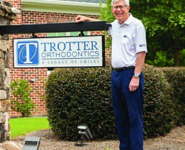 Man in front of sign