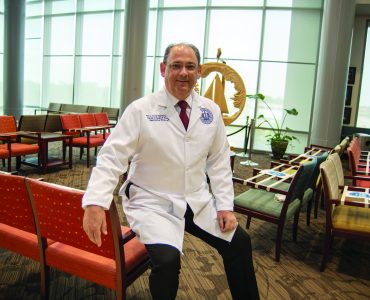 Man sitting in lobby on chair