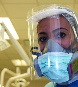 Dentist in personal protective gear due to COVID-19 pandemic